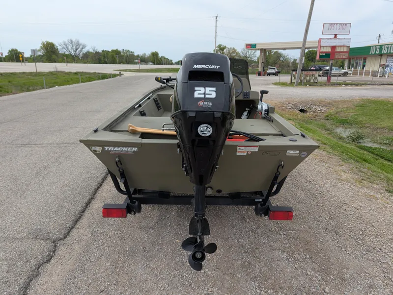 Slide: The Image of 2022 Tracker Grizzly 1648 SC boat with Mercury 25 engine on a road. - 31