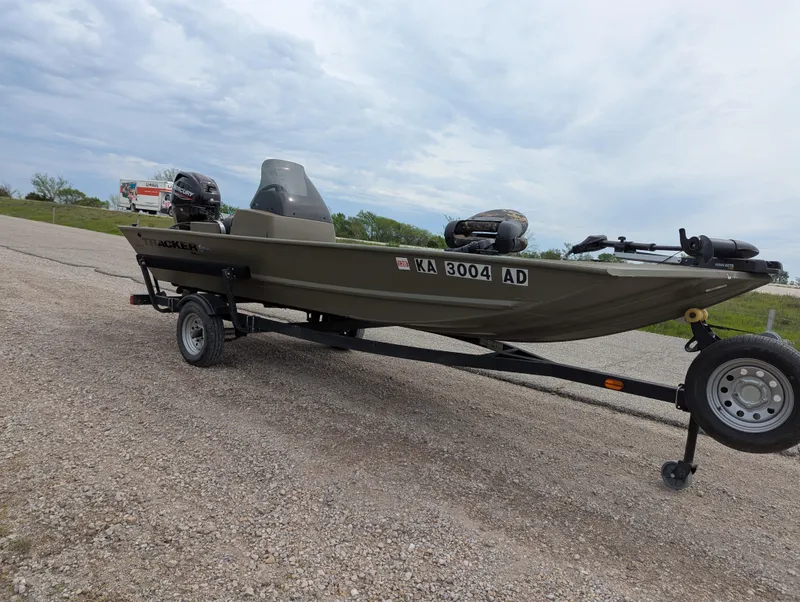 Slide: The Image of 2022 Tracker Grizzly 1648 SC boat on trailer, parked on gravel road. - 35