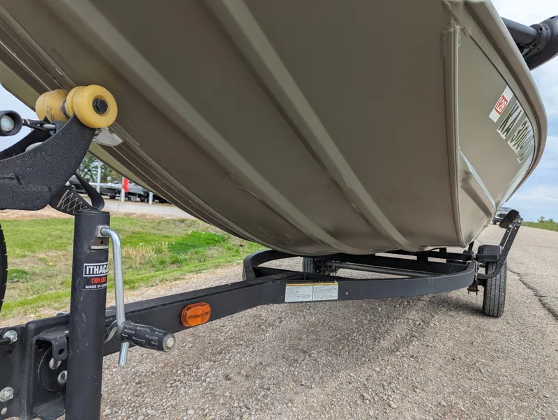 Slide: The Image of 2022 Tracker Grizzly 1648 SC boat on trailer, close-up view of hull and hitch. - 37