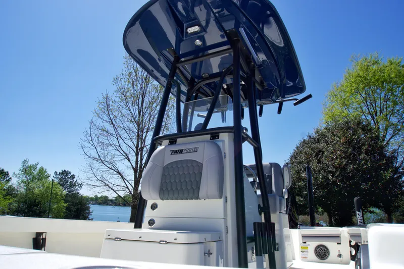 Slide: The Image of 2025 Pathfinder 2500 Hybrid boat console with T-top, set against a clear blue sky. - 10