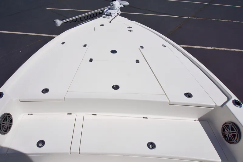 Slide: The Image of 2025 Pathfinder 2500 Hybrid boat deck with storage compartments and trolling motor. - 12