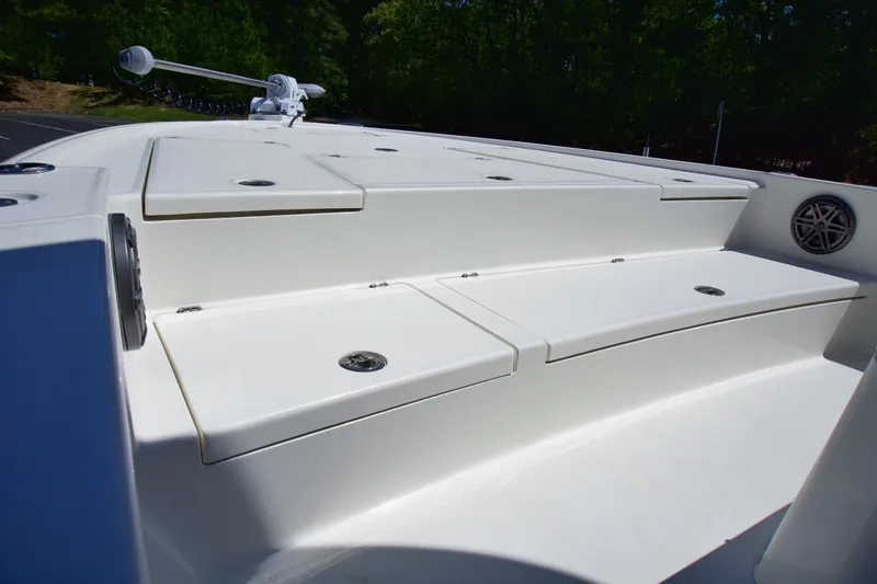 Slide: The Image of 2025 Pathfinder 2500 Hybrid boat deck with storage compartments and sleek design. - 14
