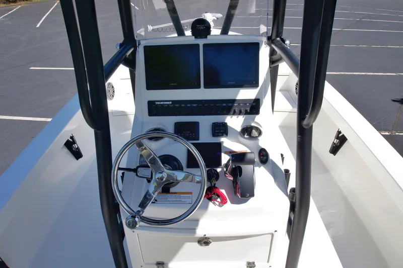 Slide: The Image of 2025 Pathfinder 2500 Hybrid boat console with dual screens and steering wheel. - 15