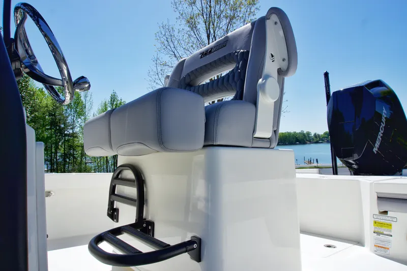 Slide: The Image of 2025 Pathfinder 2500 Hybrid boat seat and steering wheel, with lake view in background. - 16