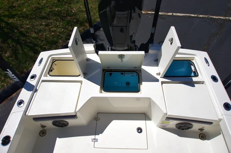 Slide: The Image of 2025 Pathfinder 2500 Hybrid boat deck with open storage compartments and livewell. - 19