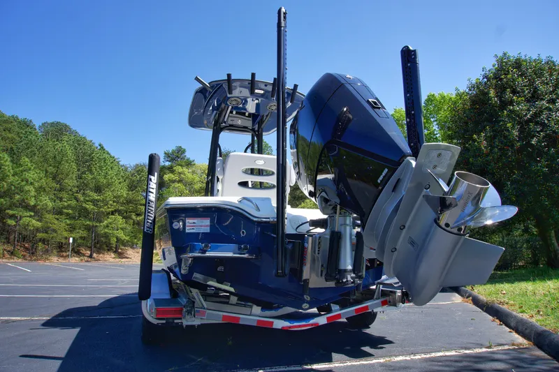 Slide: The Image of 2025 Pathfinder 2500 Hybrid boat on trailer, rear view, parked outdoors. - 4