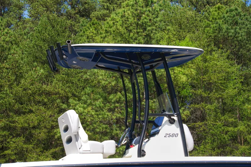 Slide: The Image of 2025 Pathfinder 2500 Hybrid boat with T-top against a forest backdrop. - 7