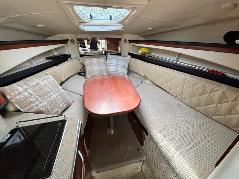 Slide: The Image of 2007 Sea Ray 260 Sundancer cabin with cozy seating, table, and skylight. - 10