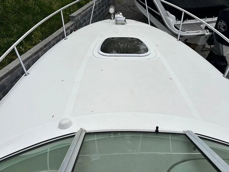 Slide: The Image of 2007 Sea Ray 260 Sundancer boat deck with hatch and railing. - 12