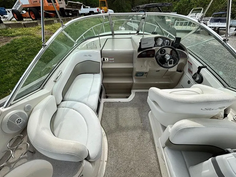 Slide: The Image of 2007 Sea Ray 260 Sundancer boat interior with white seating and dashboard. - 14