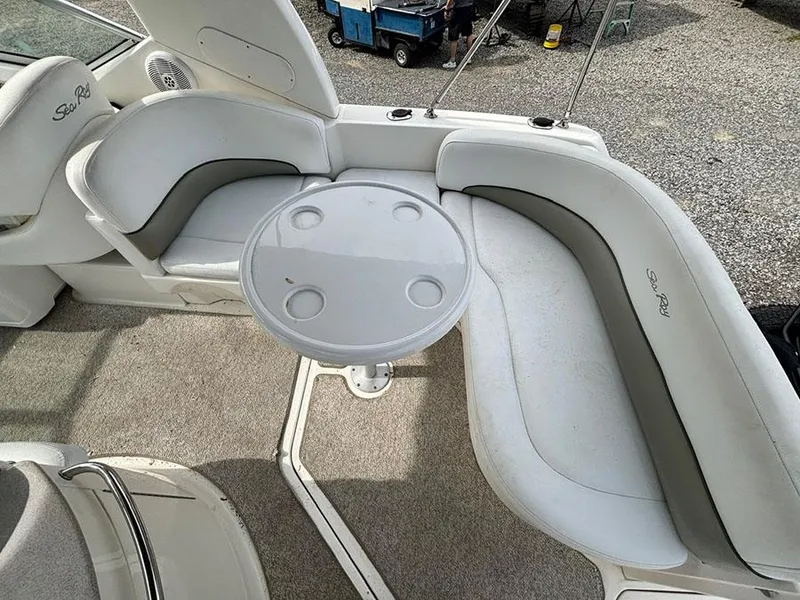 Slide: The Image of 2007 Sea Ray 260 Sundancer boat interior with curved seating and round table. - 18
