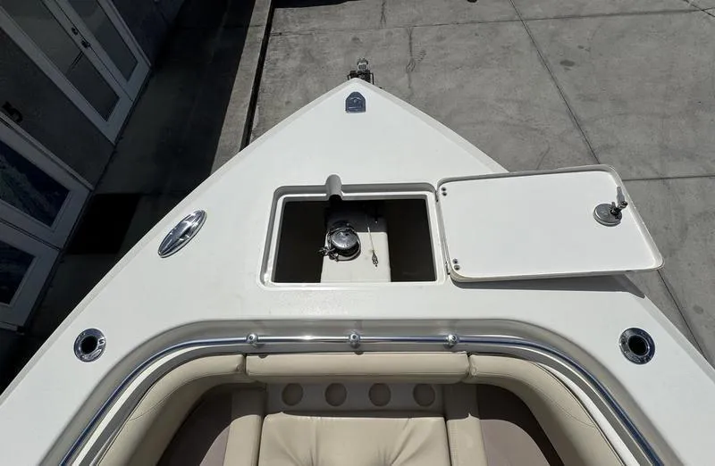 Slide: The Image of 2016 Cobia 296 Center Console boat bow with storage compartment open. - 10