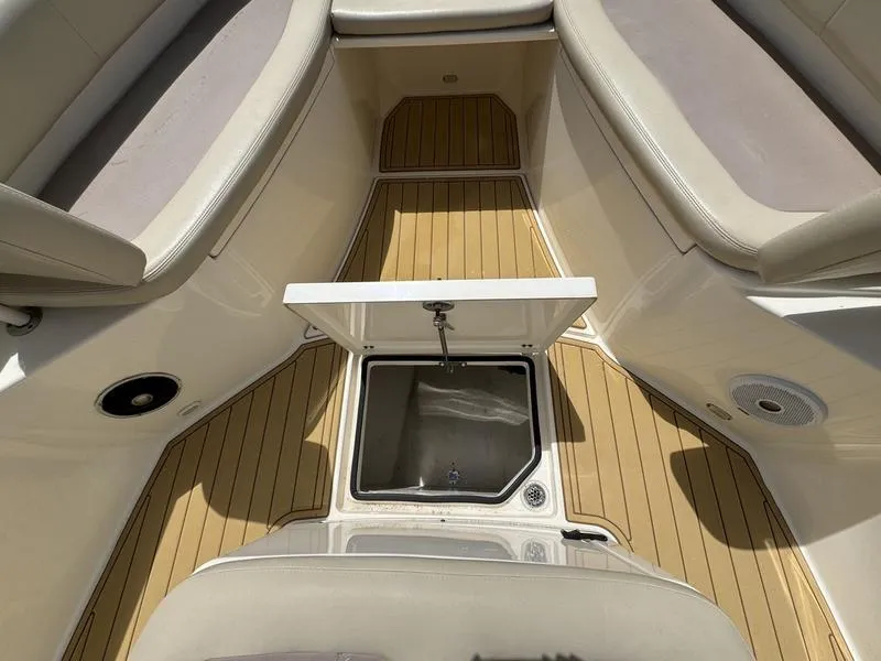 Slide: The Image of 2016 Cobia 296 Center Console boat interior with open storage compartment. - 16