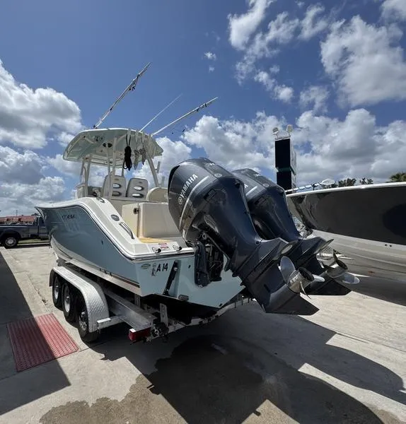 Slide: The Image of 2016 Cobia 296 Center Console boat with twin Yamaha engines on a trailer. - 4
