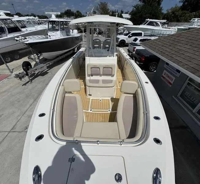 Slide: The Image of 2016 Cobia 296 Center Console boat with spacious seating, docked at a marina. - 6