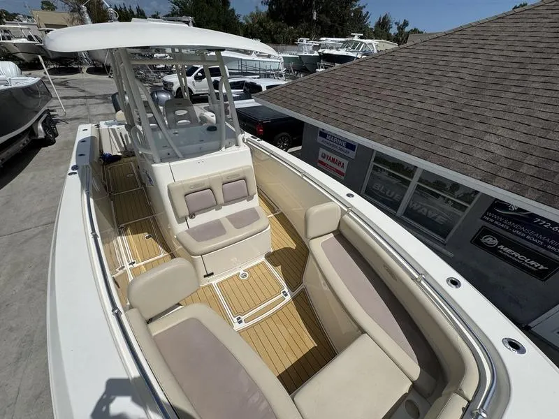 Slide: The Image of 2016 Cobia 296 Center Console boat with spacious seating and sleek design. - 8