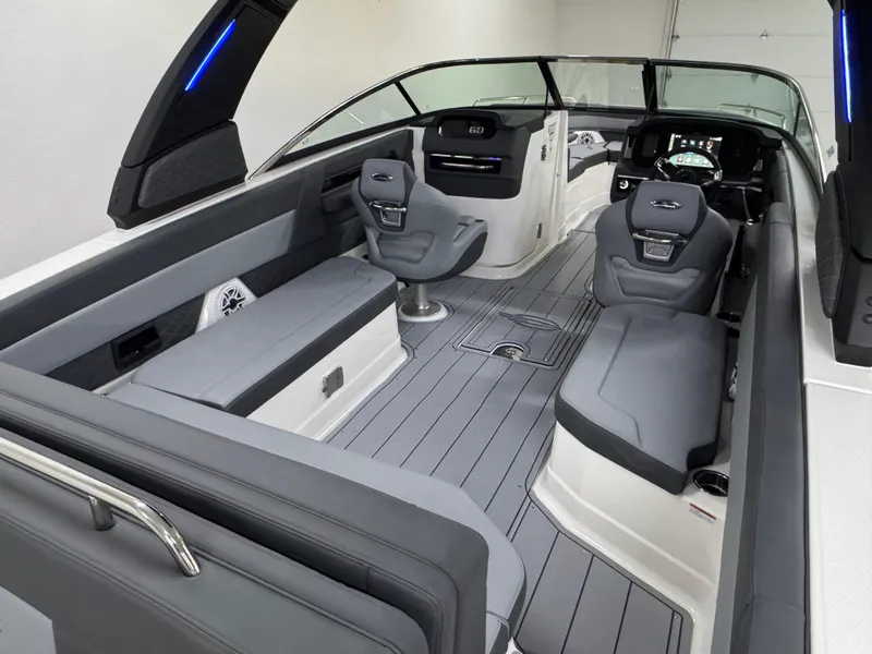Slide: The Image of 2025 Chaparral 2870 SSX boat interior with sleek gray seating and modern dashboard. - 12