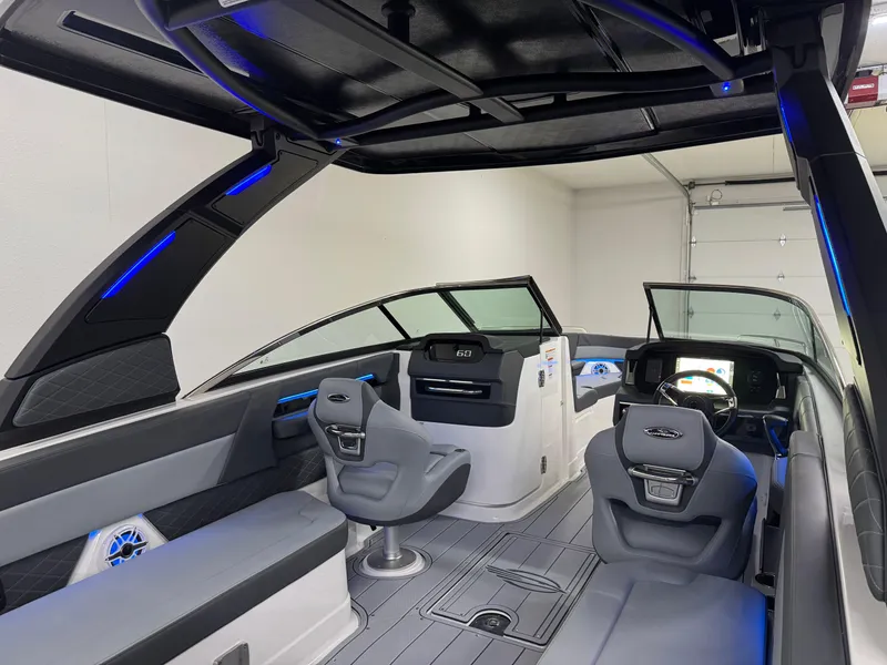 Slide: The Image of 2025 Chaparral 2870 SSX boat interior with modern seating and sleek dashboard design. - 13