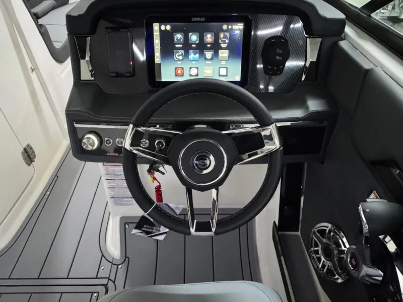 Slide: The Image of 2025 Chaparral 2870 SSX boat dashboard with touchscreen and modern steering wheel. - 15