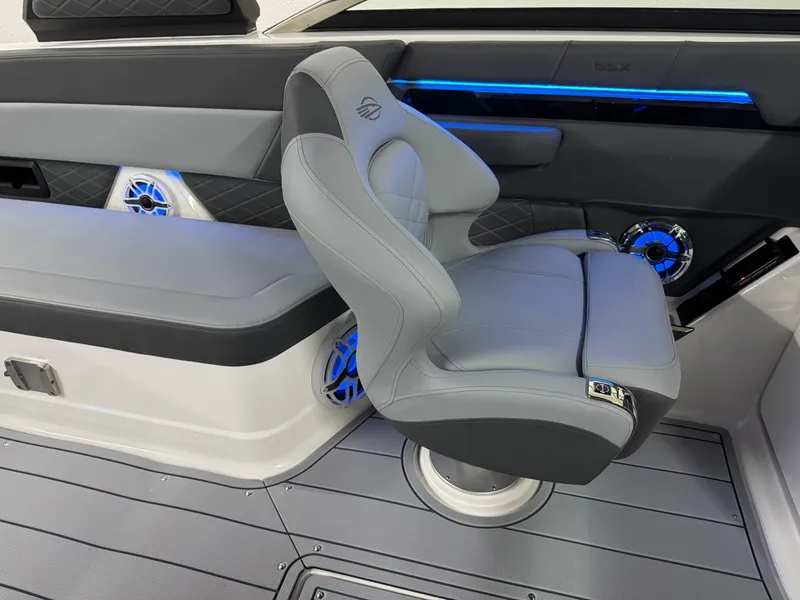 Slide: The Image of 2025 Chaparral 2870 SSX boat interior with sleek gray seating and blue LED accents. - 24