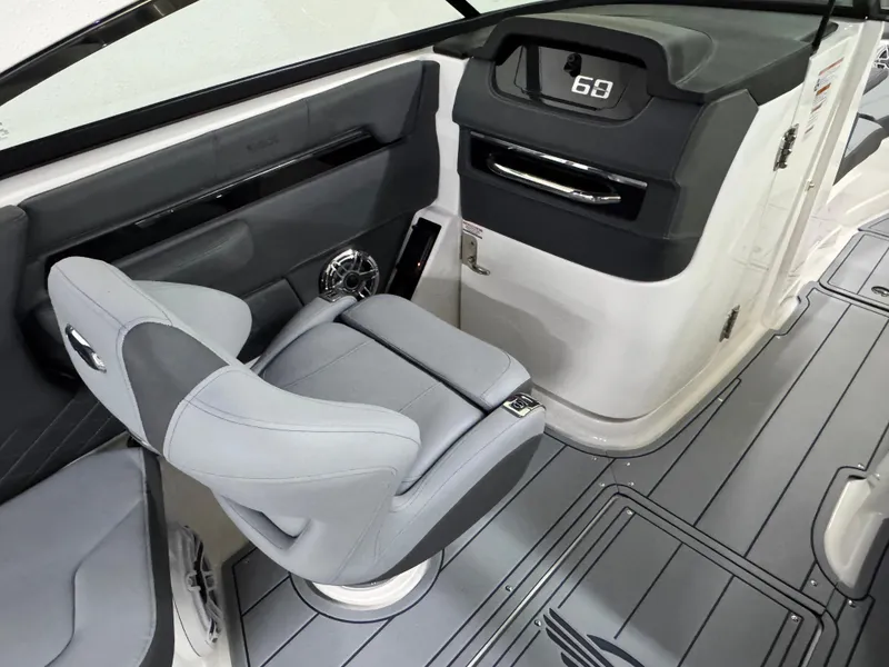 Slide: The Image of 2025 Chaparral 2870 SSX boat interior with sleek gray seating and modern dashboard. - 25