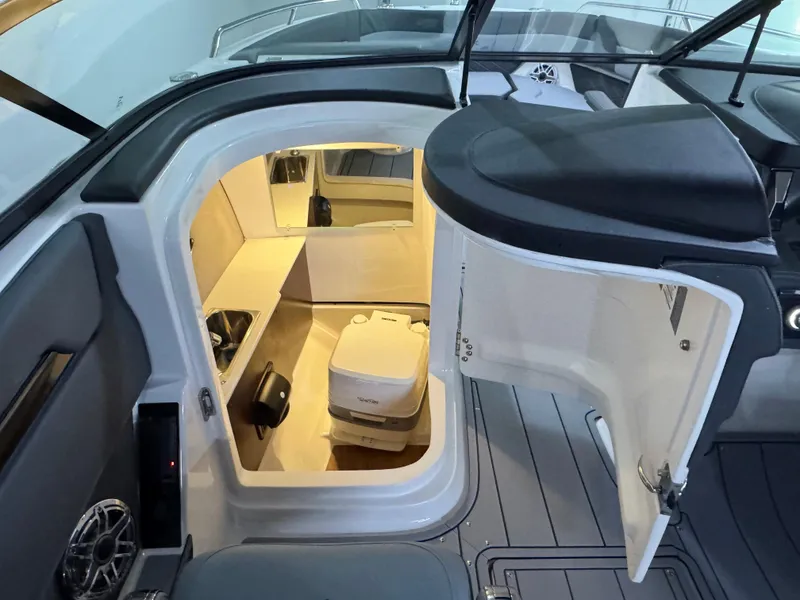 Slide: The Image of 2025 Chaparral 2870 SSX boat interior with open cabin door and visible amenities. - 27