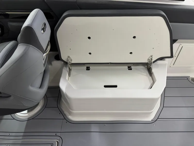 Slide: The Image of 2025 Chaparral 2870 SSX boat interior with open storage compartment and seating. - 30