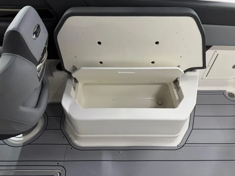 Slide: The Image of Open storage compartment on 2025 Chaparral 2870 SSX boat, featuring sleek interior design. - 31