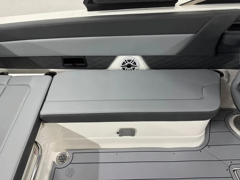 Slide: The Image of 2025 Chaparral 2870 SSX boat interior with gray seating and speaker detail. - 34
