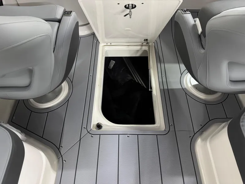Slide: The Image of 2025 Chaparral 2870 SSX boat interior with open storage compartment and seating. - 37
