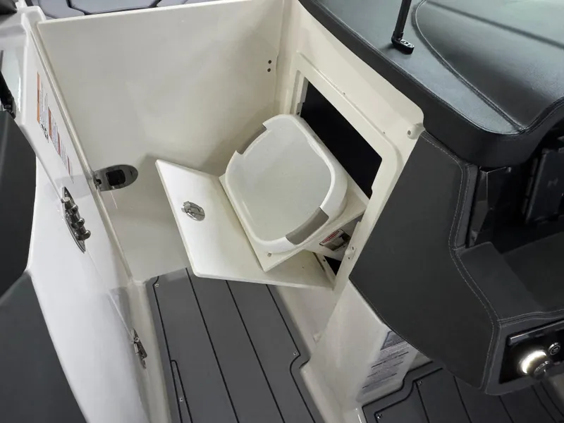 Slide: The Image of 2025 Chaparral 2870 SSX boat interior with open storage compartment and sleek design. - 39