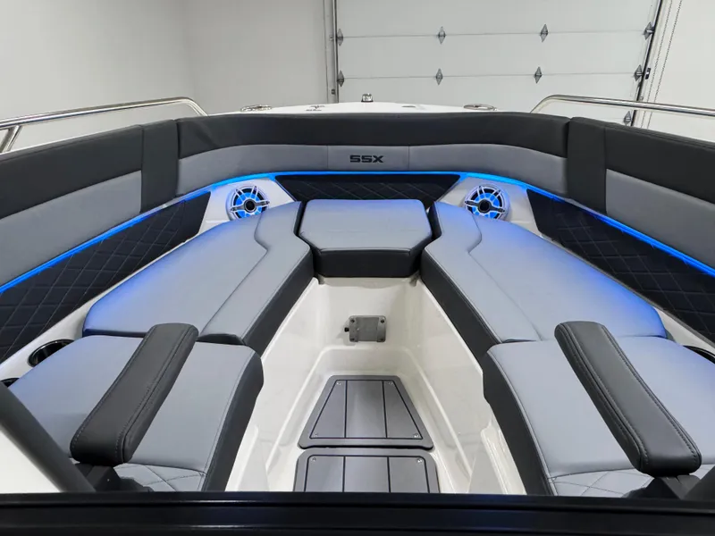 Slide: The Image of 2025 Chaparral 2870 SSX boat interior with sleek seating and blue LED lighting. - 40