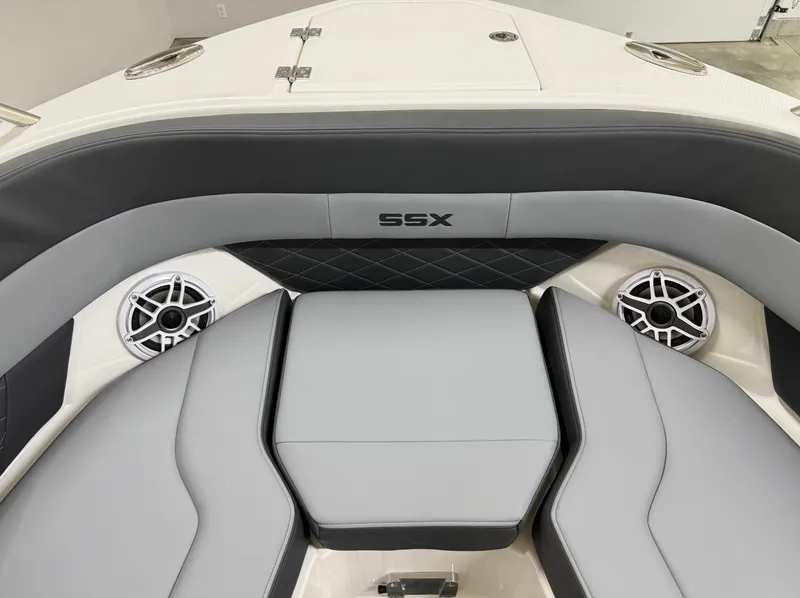 Slide: The Image of 2025 Chaparral 2870 SSX boat interior with gray seating and built-in speakers. - 42