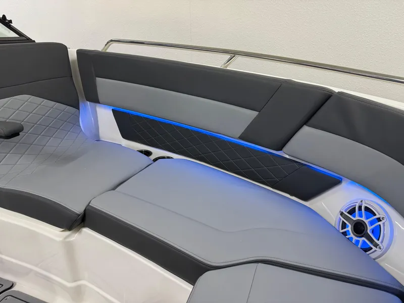 Slide: The Image of 2025 Chaparral 2870 SSX boat interior with gray seating and blue LED lighting. - 44