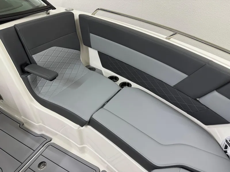 Slide: The Image of 2025 Chaparral 2870 SSX boat interior with gray cushioned seating and cup holders. - 45