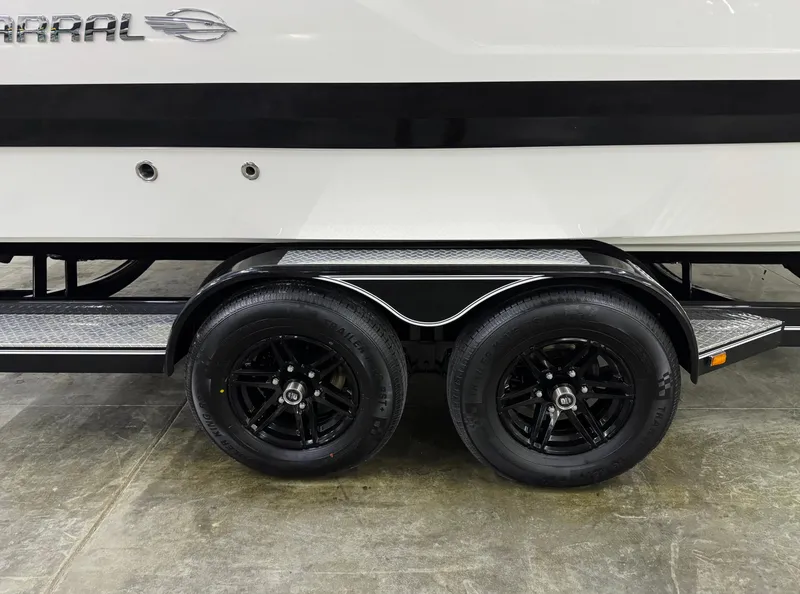 Slide: The Image of 2025 Chaparral 2870 SSX boat trailer with dual black wheels and sleek design. - 47