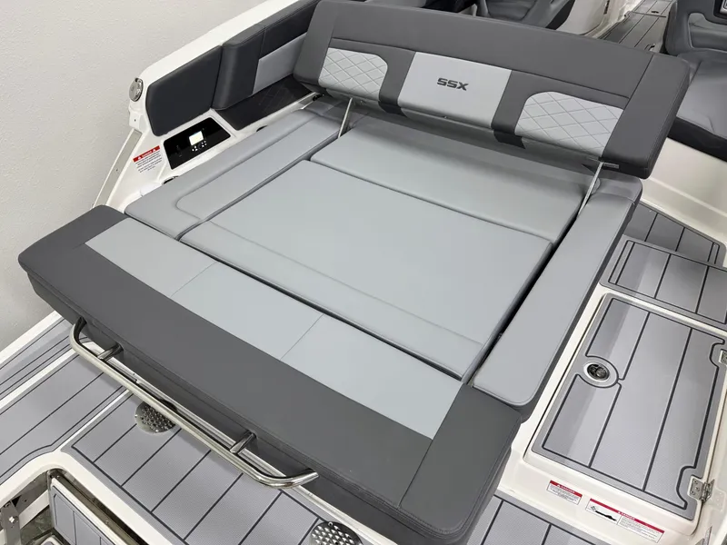 Slide: The Image of 2025 Chaparral 2870 SSX boat interior with gray seating and SSX logo. - 8