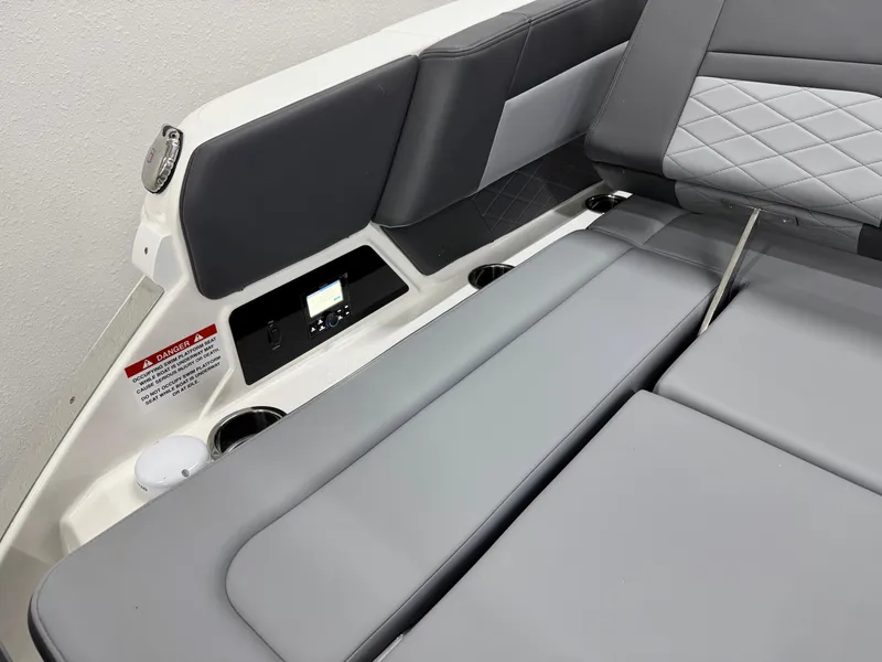 Slide: The Image of 2025 Chaparral 2870 SSX boat interior with gray seating and control panel. - 9