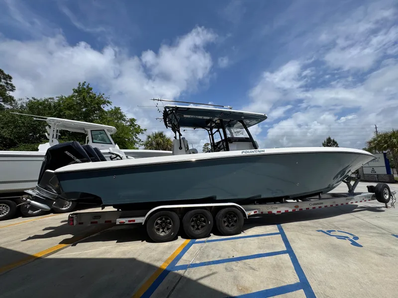 Slide: The Image of 2021 Fountain 38TE boat on trailer under cloudy sky. - 12
