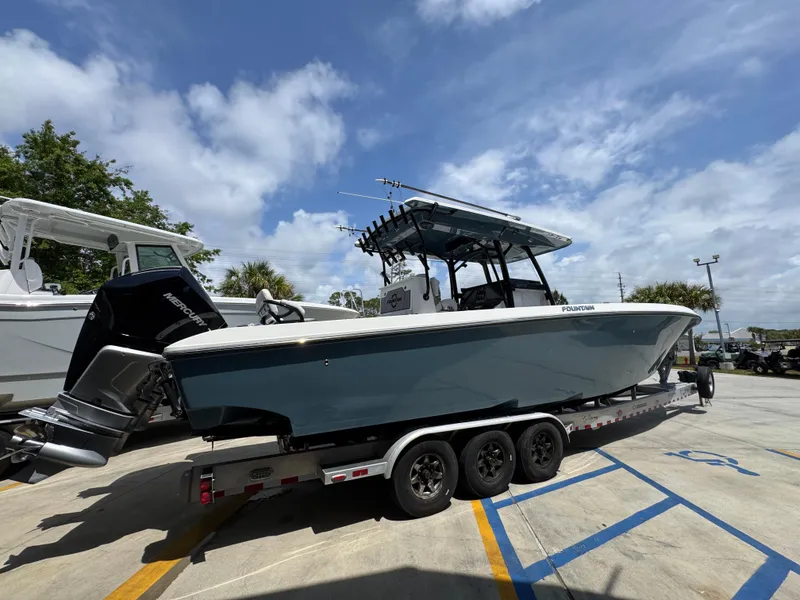 Slide: The Image of 2021 Fountain 38TE boat on trailer under blue sky. - 13