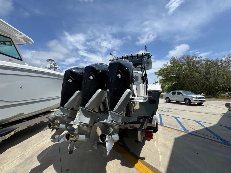Slide: The Image of 2021 Fountain 38TE boat with triple outboard engines in a parking lot. - 15