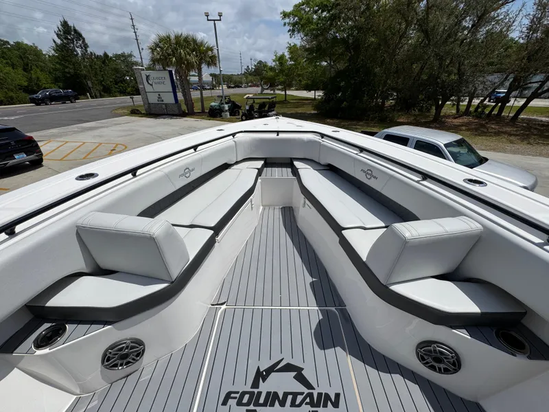 Slide: The Image of 2021 Fountain 38TE boat with spacious seating and sleek design in a parking area. - 19