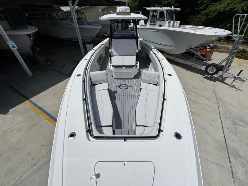 Slide: The Image of 2021 Fountain 38TE boat with spacious seating, docked alongside other boats. - 20