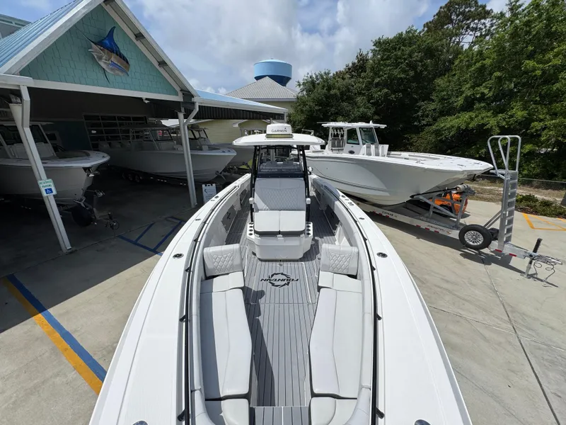 Slide: The Image of 2021 Fountain 38TE boat displayed at a marina with other boats. - 21