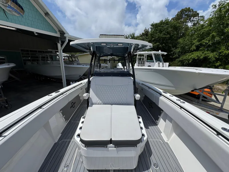 Slide: The Image of 2021 Fountain 38TE boat with sleek design, docked outdoors under a cloudy sky. - 23