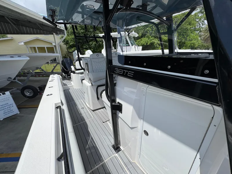 Slide: The Image of 2021 Fountain 38TE boat with sleek design and modern interior, docked outdoors. - 27