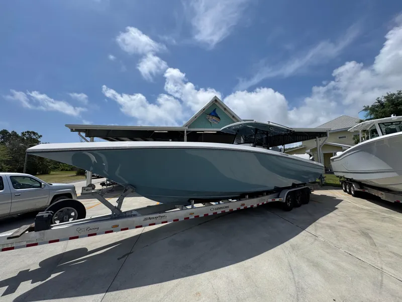 Slide: The Image of 2021 Fountain 38TE boat on trailer under clear blue sky. - 3
