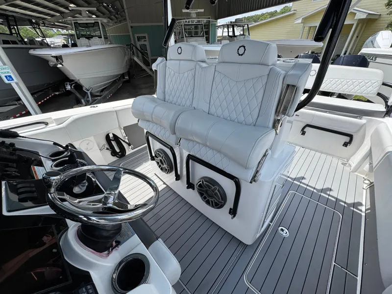 Slide: The Image of Luxurious 2021 Fountain 38TE boat interior with plush seating and modern steering wheel. - 30
