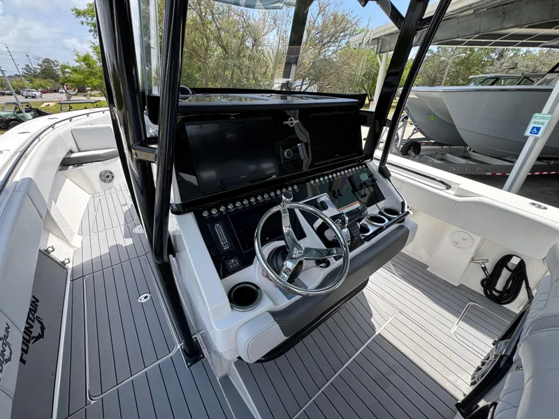 Slide: The Image of 2021 Fountain 38TE boat cockpit with modern steering and control panel. - 32