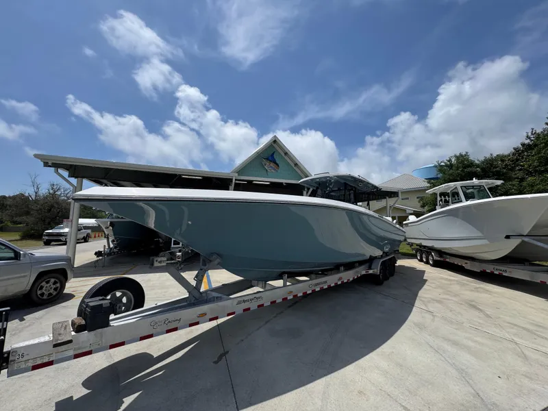 Slide: The Image of 2021 Fountain 38TE boat on trailer under clear blue sky. - 4